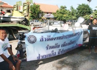 Local police load up boats and jet skis to bring supplies to flood victims in Pathum Thani.